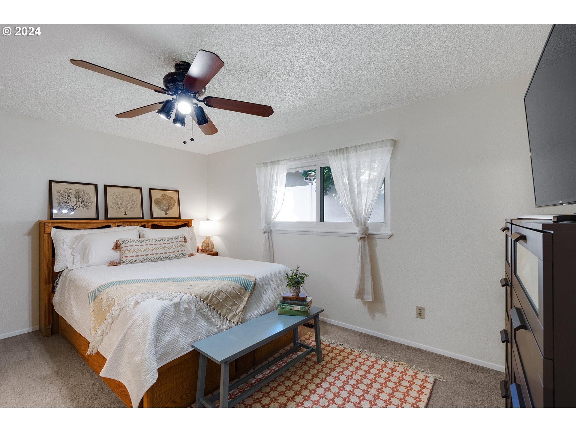 7946 Southeast 103rd Avenue Portland, OR 97266 - Photo 17 of 32 a bedroom with a bed and a chandelier