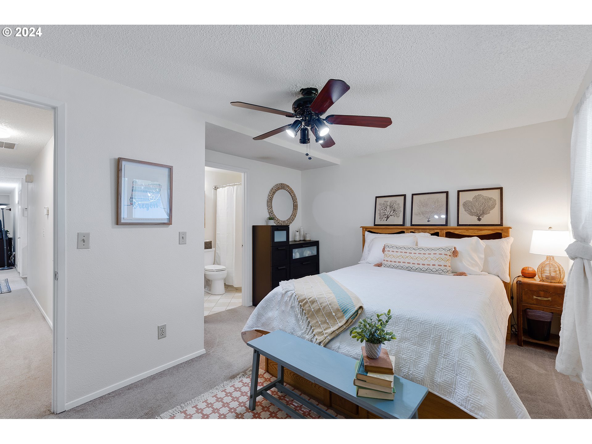 7946 Southeast 103rd Avenue Portland, OR 97266 - Photo 18 of 32 a bedroom with a bed a dresser and potted plant