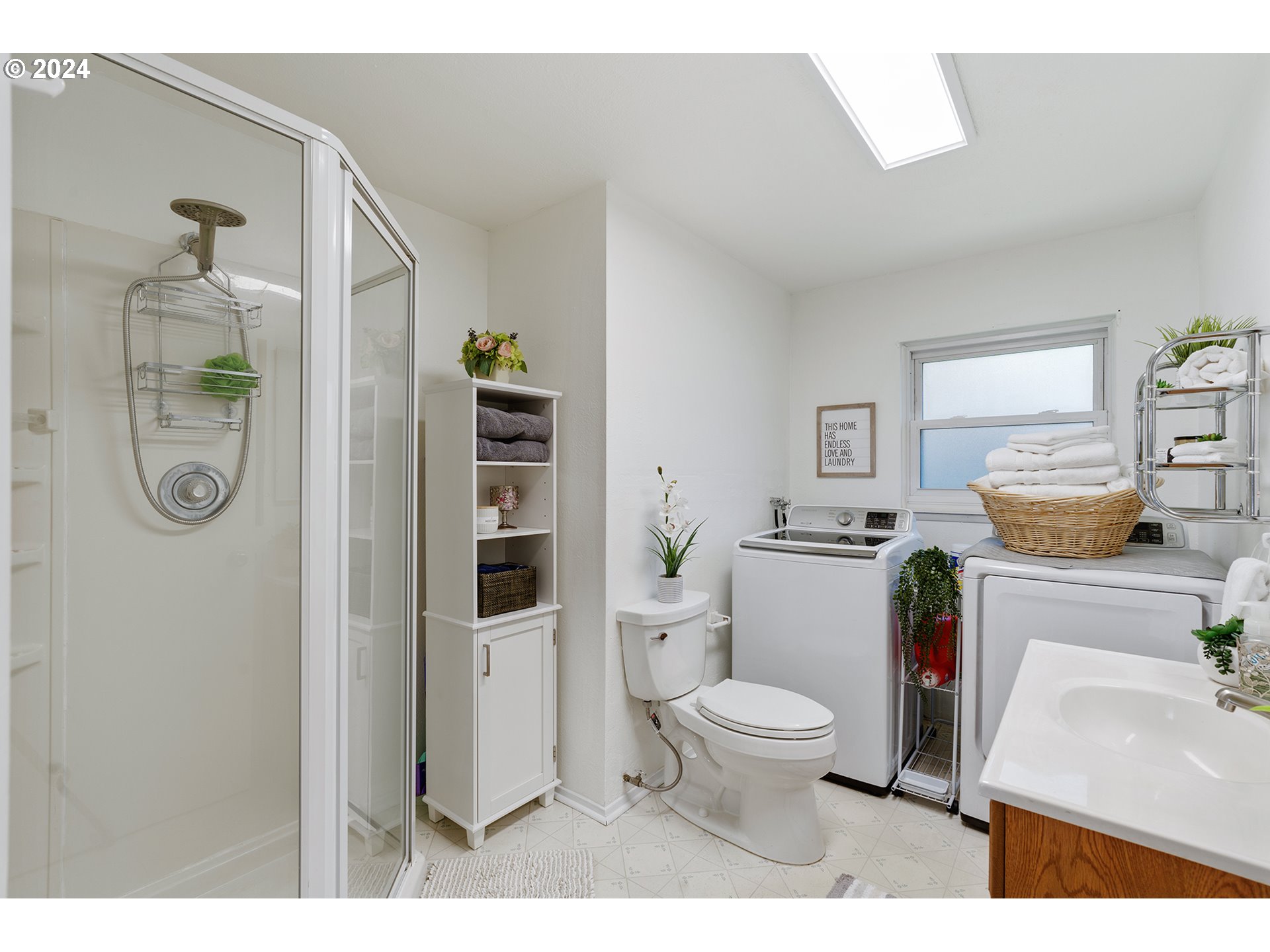 7946 Southeast 103rd Avenue Portland, OR 97266 - Photo 23 of 32 a bathroom with a toilet a sink and a shower