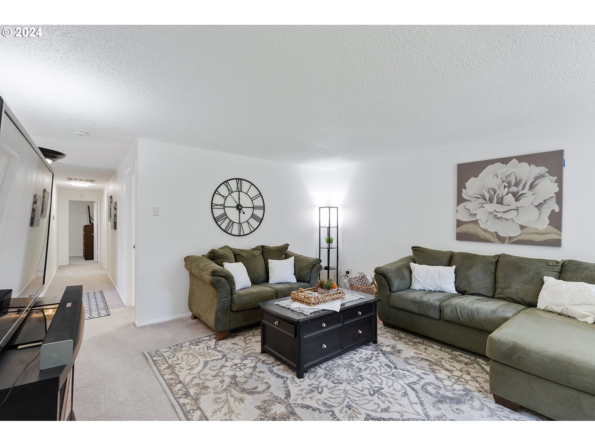 7946 Southeast 103rd Avenue Portland, OR 97266 - Photo 8 of 32 a living room with furniture a rug and a wall painting