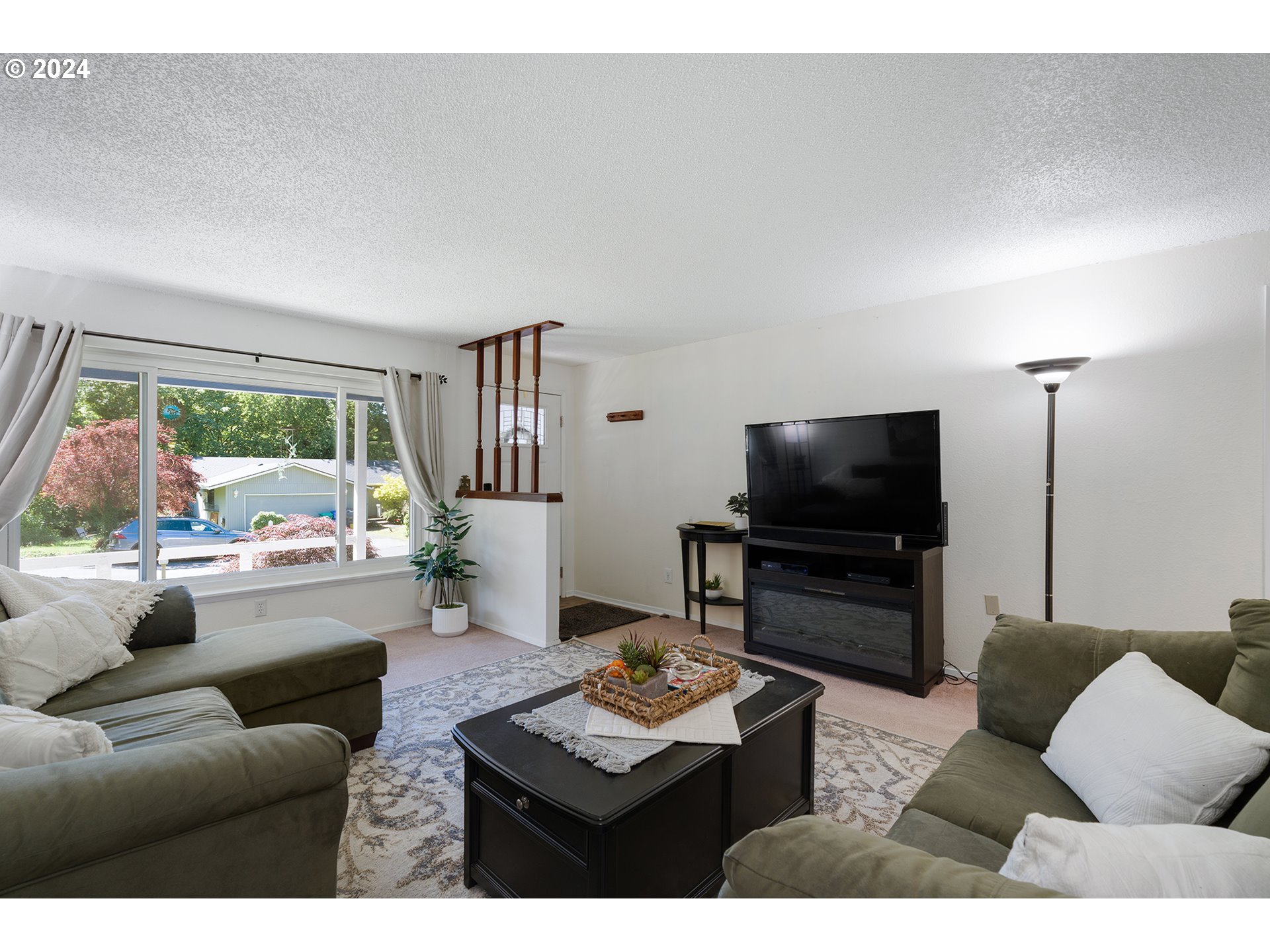 7946 Southeast 103rd Avenue Portland, OR 97266 - Photo 9 of 32 a living room with furniture and a flat screen tv