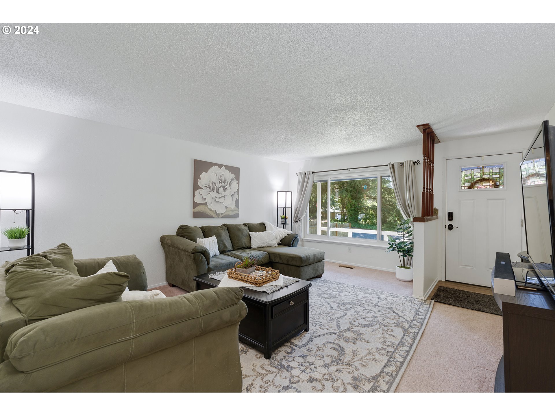 7946 Southeast 103rd Avenue Portland, OR 97266 - Photo 10 of 32 a living room with furniture and a large window