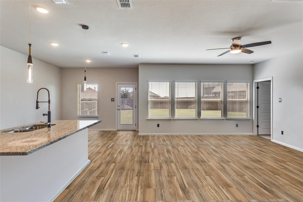 516 Palmito Ranch Road Fort Worth, TX 76131 - Photo 14 of 32 a large kitchen with granite countertop a large window and a sink