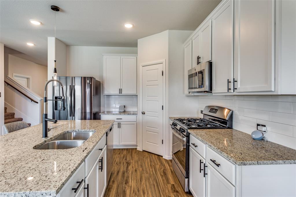 516 Palmito Ranch Road Fort Worth, TX 76131 - Photo 16 of 32 a kitchen with stainless steel appliances granite countertop a sink stove and refrigerator