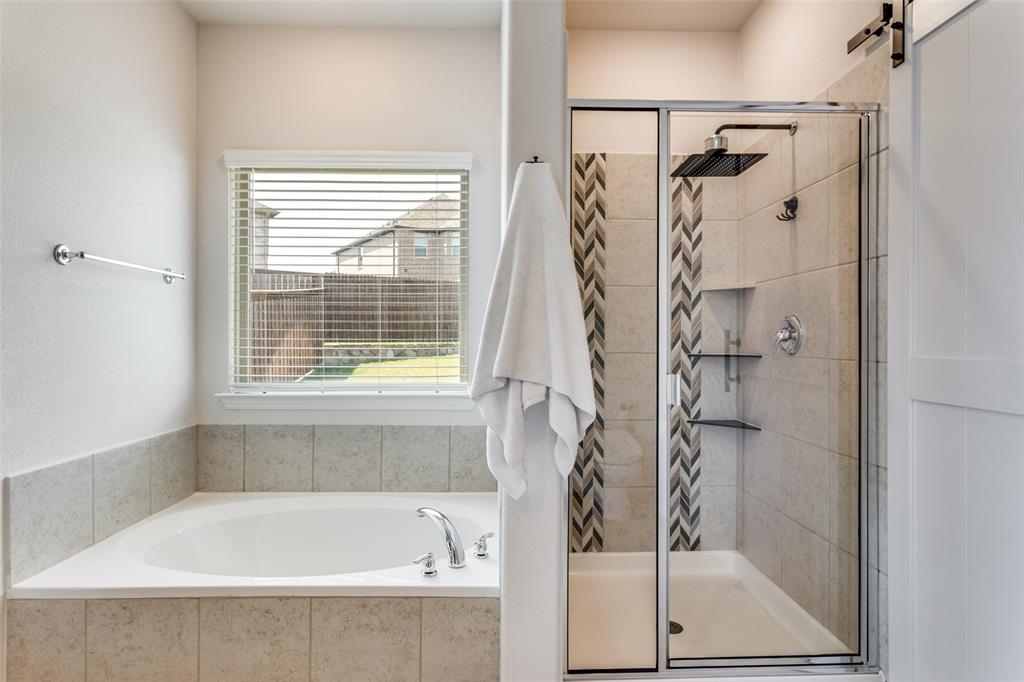 516 Palmito Ranch Road Fort Worth, TX 76131 - Photo 20 of 32 a bathroom with a bathtub and a shower