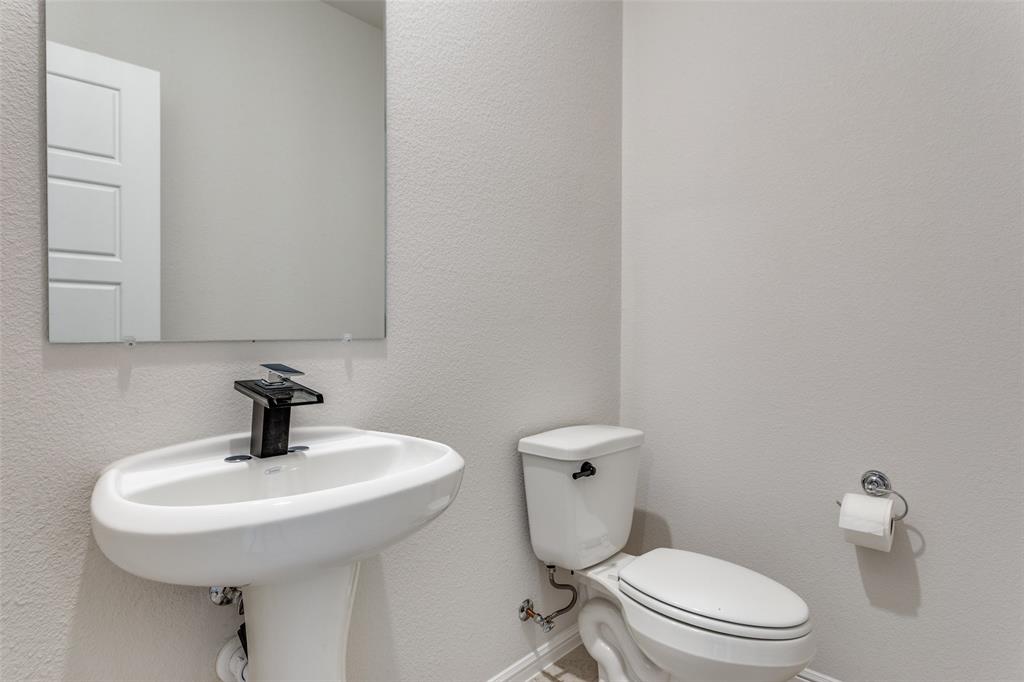 516 Palmito Ranch Road Fort Worth, TX 76131 - Photo 21 of 32 a bathroom with a sink a toilet and mirror