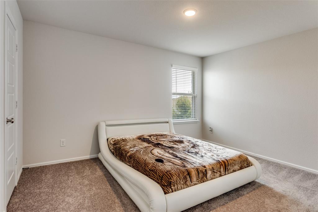 516 Palmito Ranch Road Fort Worth, TX 76131 - Photo 24 of 32 a bedroom with a bed and window