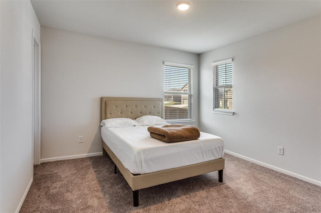 516 Palmito Ranch Road Fort Worth, TX 76131 - Photo 25 of 32 a bedroom with a bed and a window
