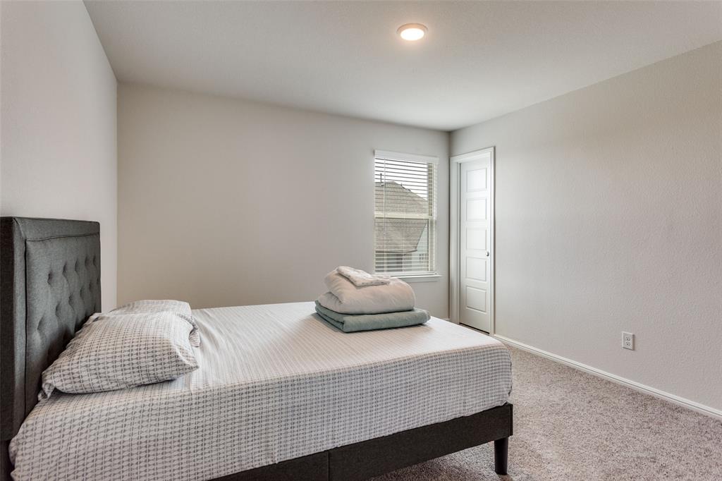 516 Palmito Ranch Road Fort Worth, TX 76131 - Photo 26 of 32 a bedroom with a bed and window