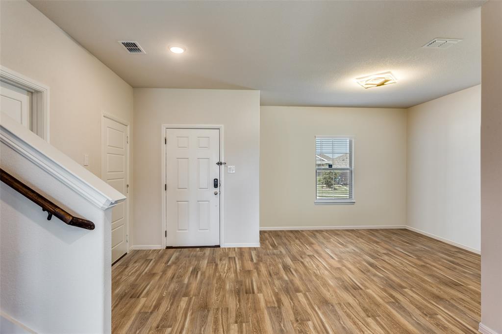 516 Palmito Ranch Road Fort Worth, TX 76131 - Photo 8 of 32 a view of an empty room with wooden floor and a window