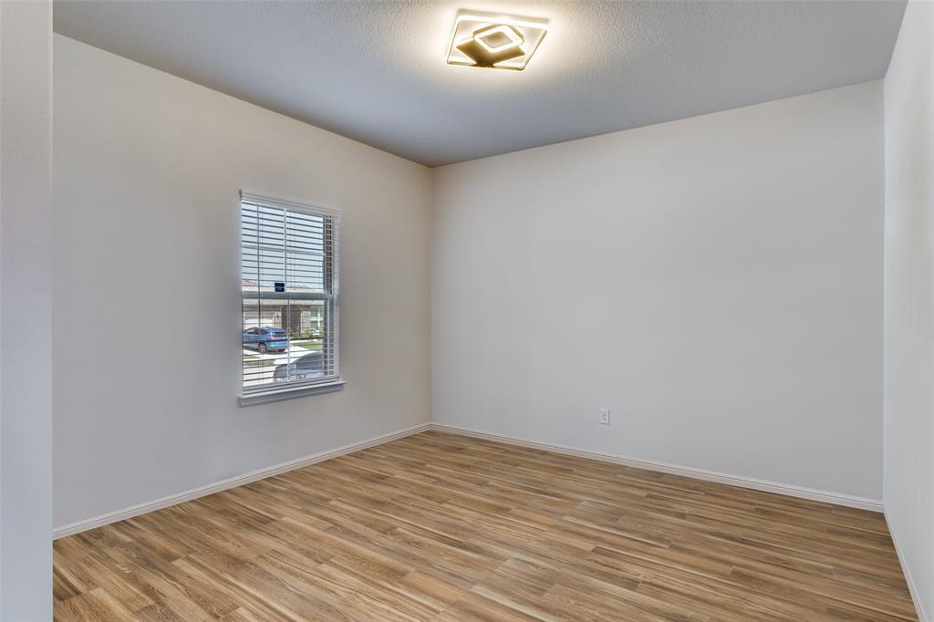 516 Palmito Ranch Road Fort Worth, TX 76131 - Photo 10 of 32 a view of empty room with wooden floor and fan