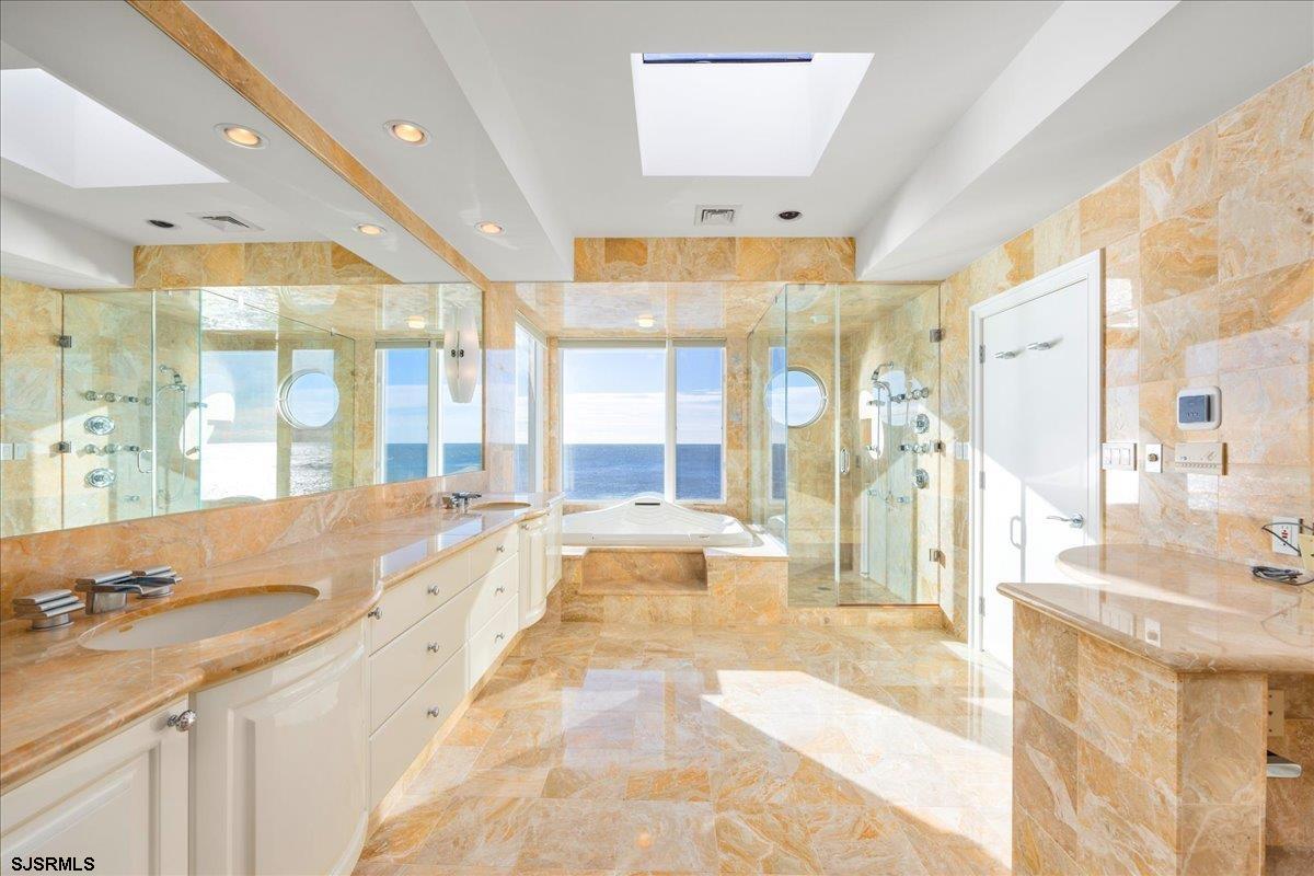 9 Point Drive Longport, NJ 08403 - Photo 29 of 38 a large bathroom with a large tub and shower