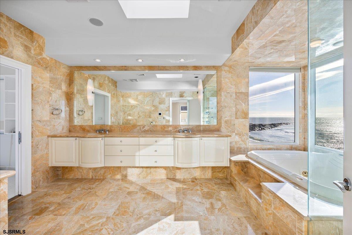 9 Point Drive Longport, NJ 08403 - Photo 30 of 38 a large bathroom with a large tub and shower