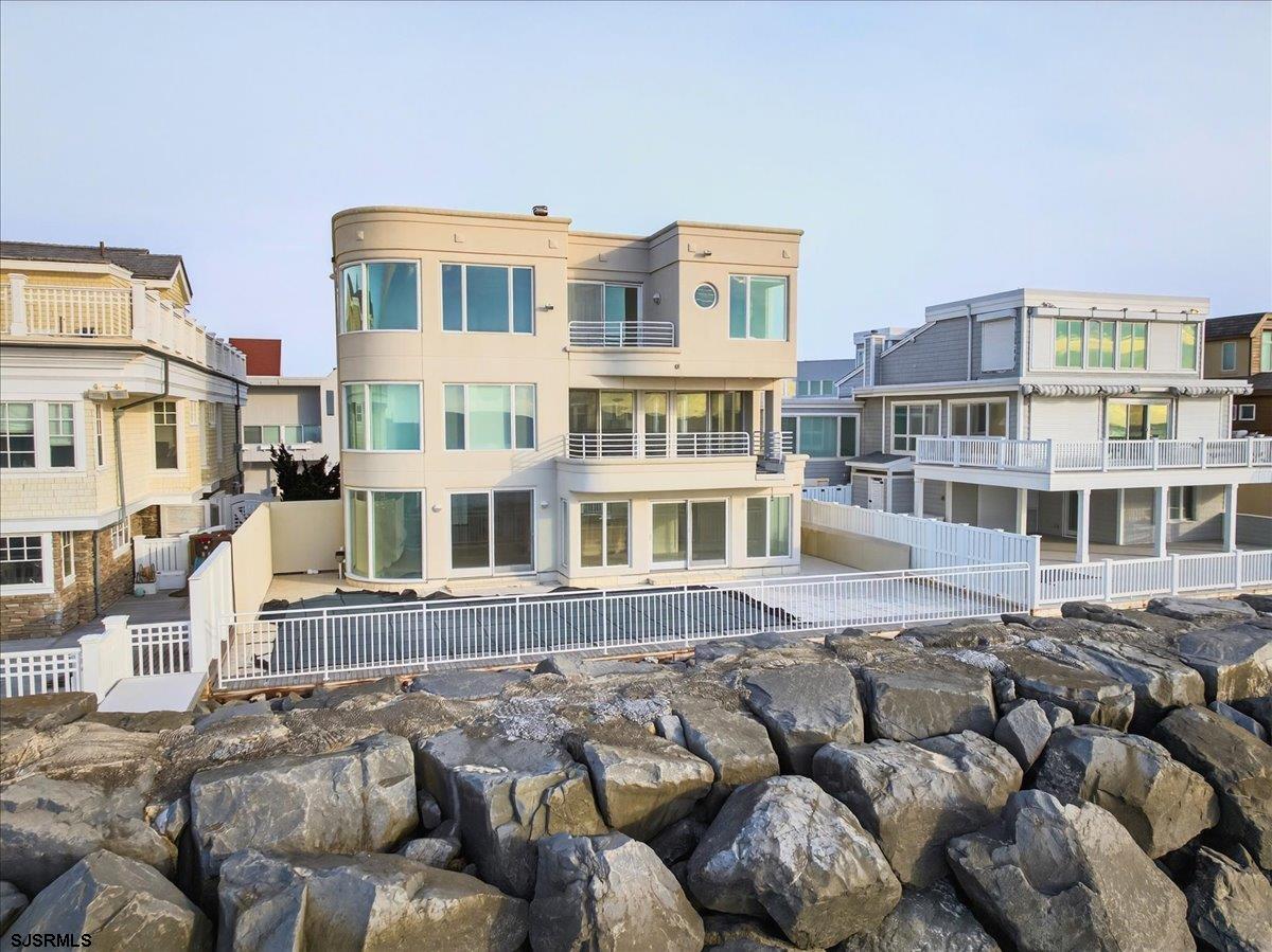 9 Point Drive Longport, NJ 08403 - Photo 3 of 38 a large building with a lot of windows