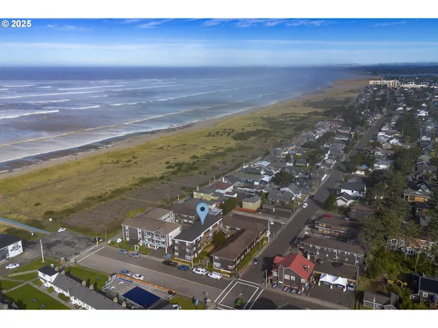 an aerial view of a residential apartment building with a yard