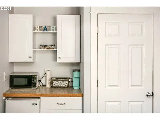 a kitchen with stainless steel appliances granite countertop a sink a stove and a microwave