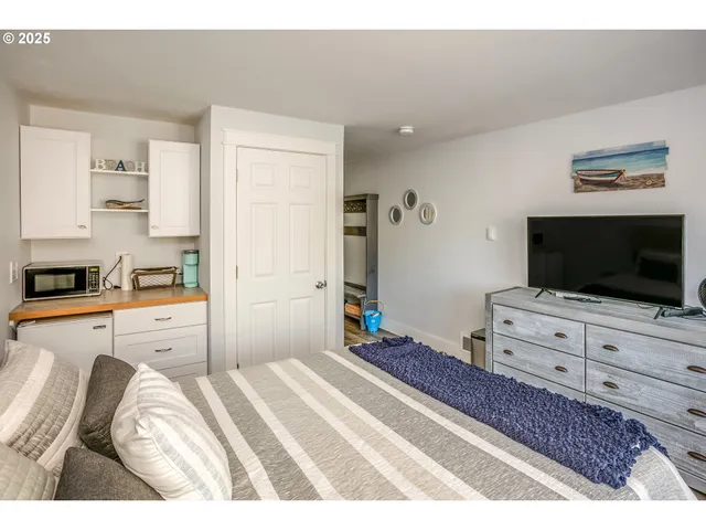a bedroom with a bed and a flat screen tv in it