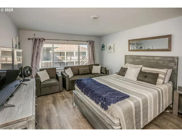 a bedroom with a bed and a couch