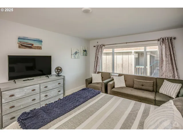 a bedroom with a bed and flat screen tv