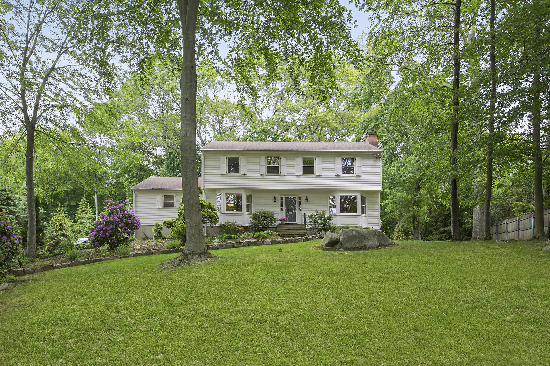 a front view of a house with a yard table and chairs