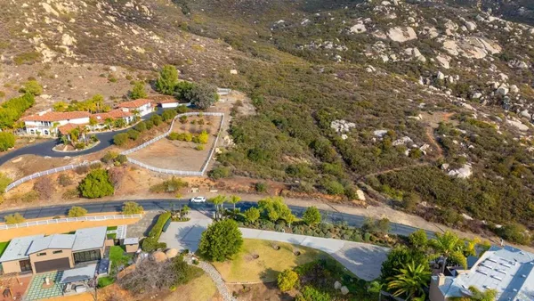 an aerial view of residential houses with outdoor space