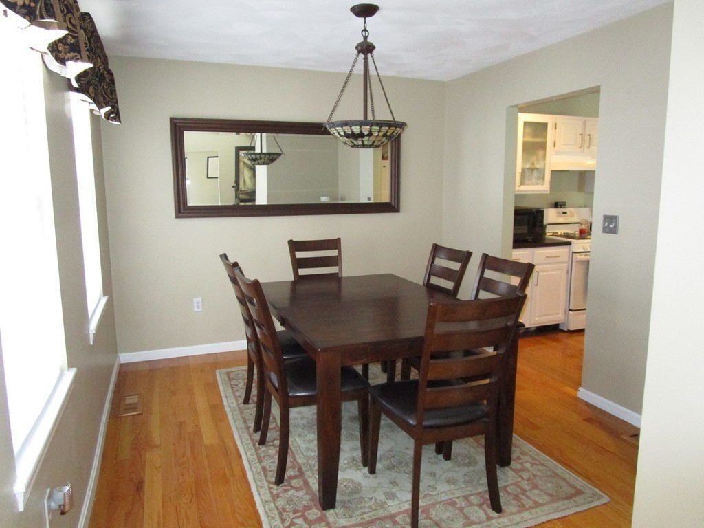 309 Acropolis Road Lowell, MA 01854 - Photo 5 of 29 a view of a dining room with furniture and wooden floor