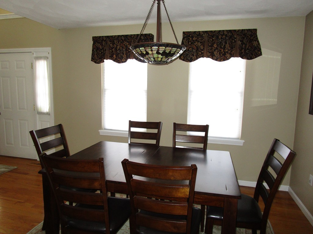 309 Acropolis Road Lowell, MA 01854 - Photo 6 of 29 a view of a dining room with furniture and window