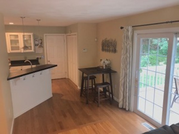 309 Acropolis Road Lowell, MA 01854 - Photo 8 of 29 a room with a table and chairs in it