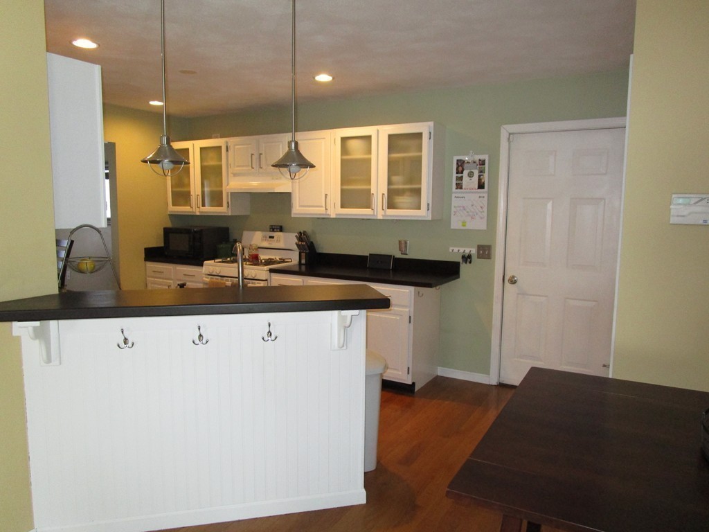 309 Acropolis Road Lowell, MA 01854 - Photo 9 of 29 a kitchen with a sink and cabinets