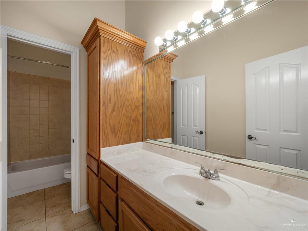 4414 Water's Edge Harlingen, TX 78552 - Photo 13 of 32 a bathroom with a sink and a mirror