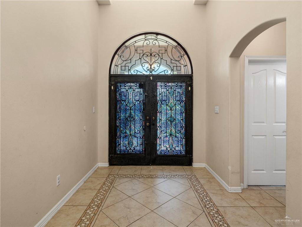 4414 Water's Edge Harlingen, TX 78552 - Photo 2 of 32 an empty room with windows mirror and door