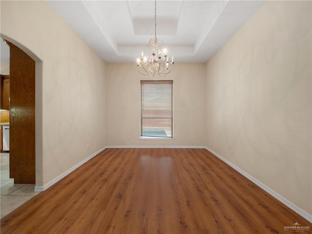 4414 Water's Edge Harlingen, TX 78552 - Photo 5 of 32 a view of an empty room with wooden floor and a window