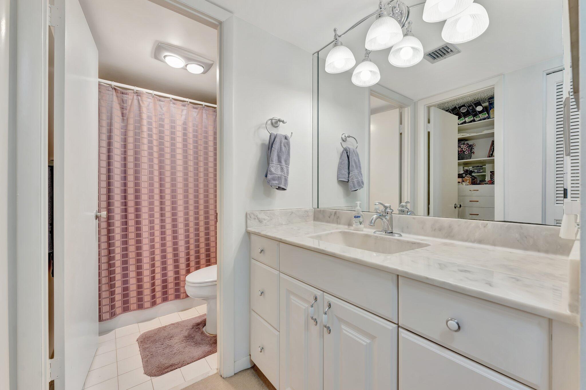 10777 West Sample Road, Unit 207 Coral Springs, FL 33065 - Photo 20 of 48 a bathroom with a sink and a mirror