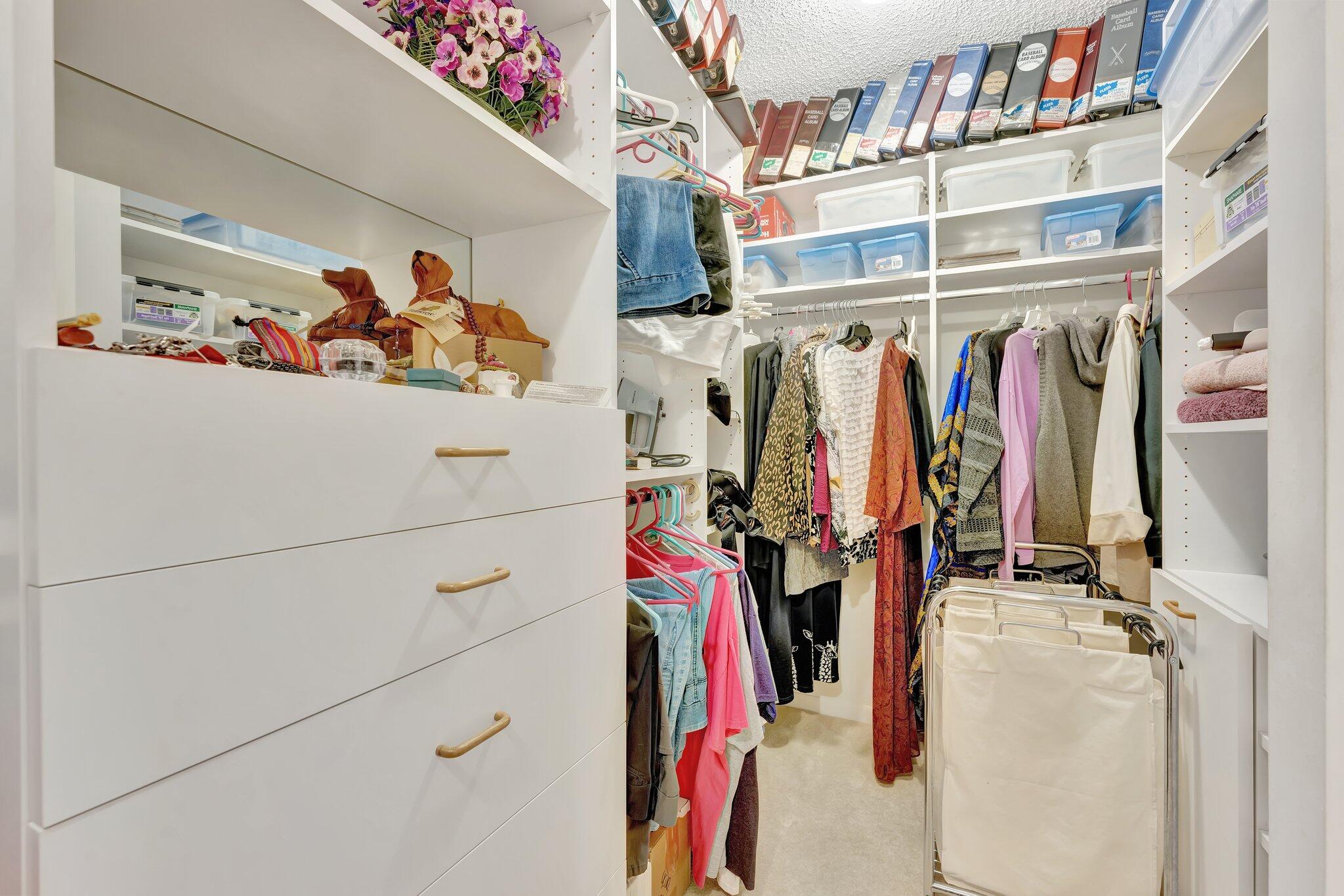 10777 West Sample Road, Unit 207 Coral Springs, FL 33065 - Photo 22 of 48 a view of walk in closet with clothes and shoes