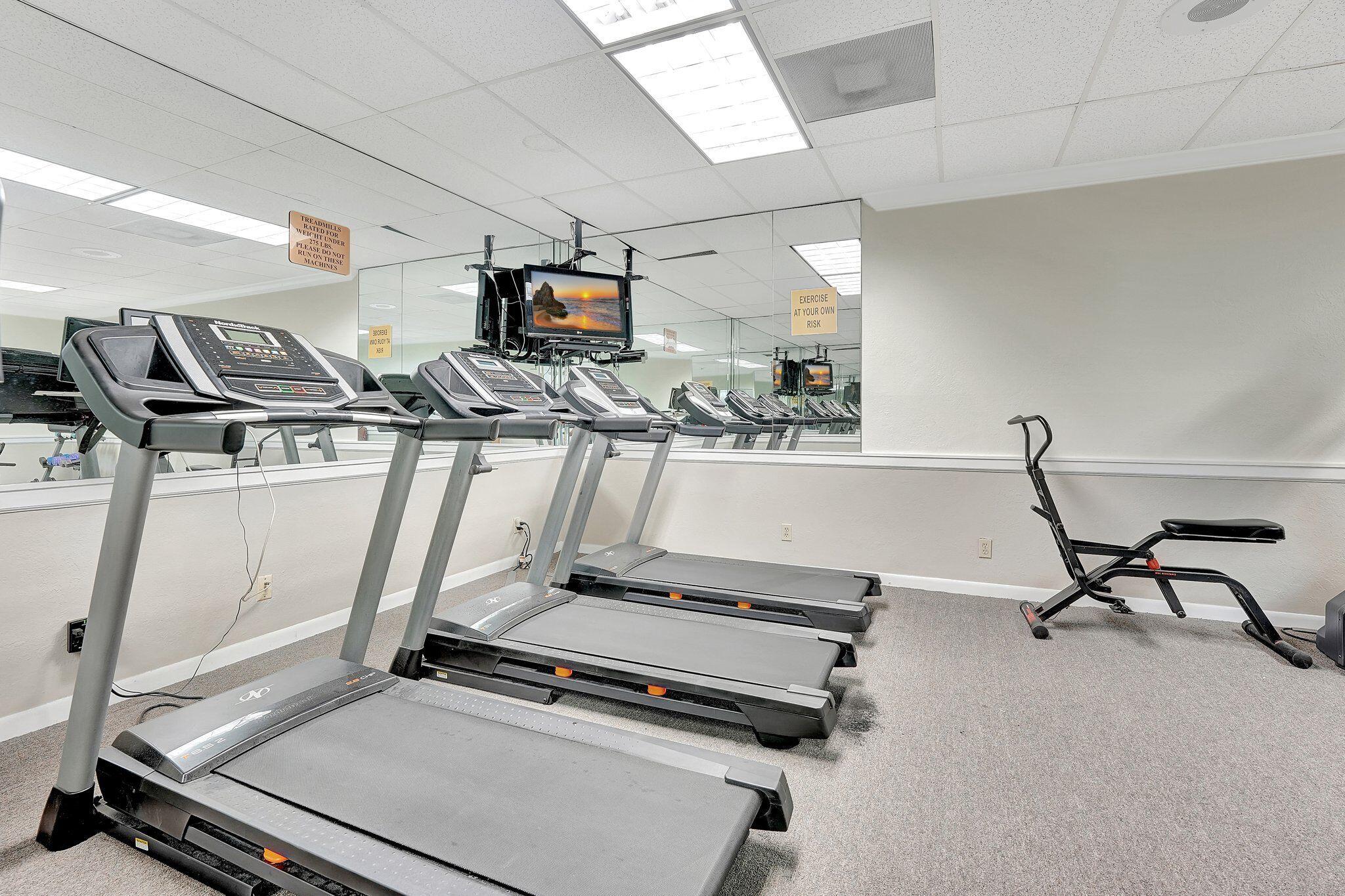 10777 West Sample Road, Unit 207 Coral Springs, FL 33065 - Photo 35 of 48 a room with gym equipment and a view of living room