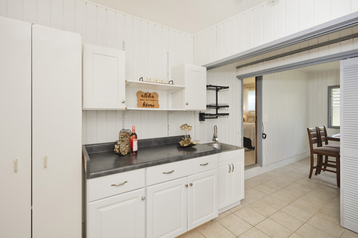 49 Iiwipolena Road Hilo, HI 96720 - Photo 16 of 30 a kitchen with granite countertop white cabinets and white appliances