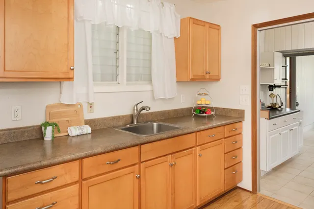 a kitchen with stainless steel appliances granite countertop a sink a stove and cabinets