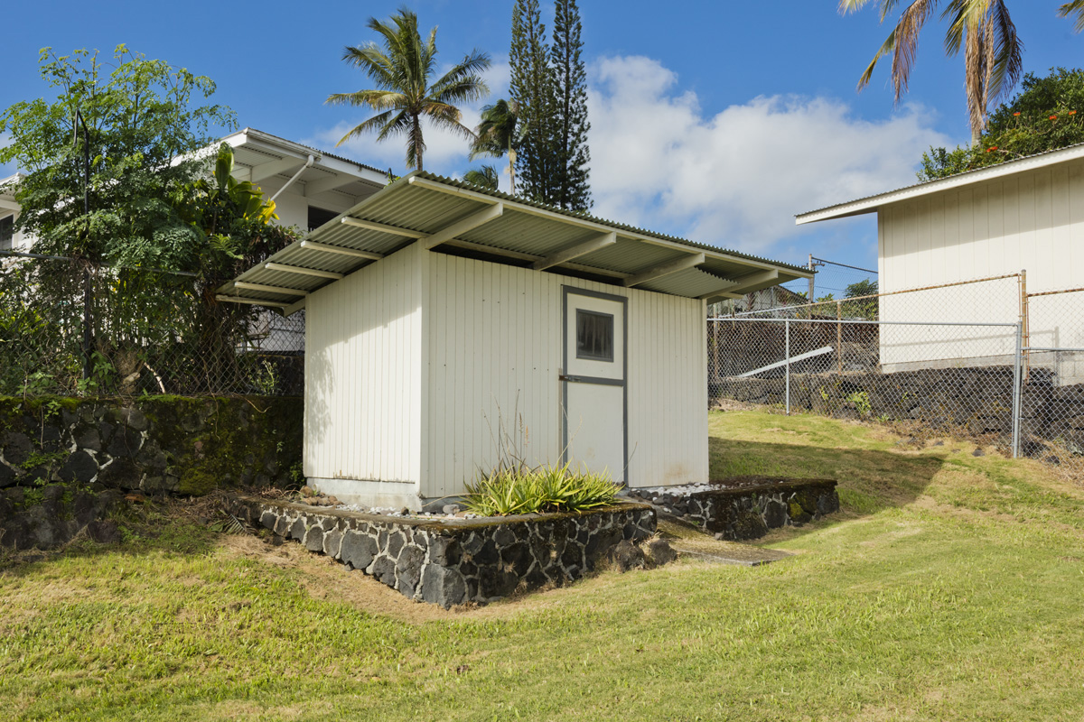 49 Iiwipolena Road Hilo, HI 96720 - Photo 27 of 30 a white house that has a small yard and a large tree