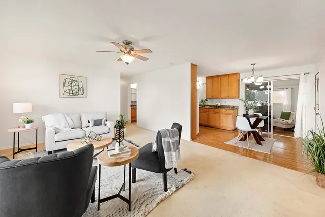 a living room with furniture a flat screen tv and a table