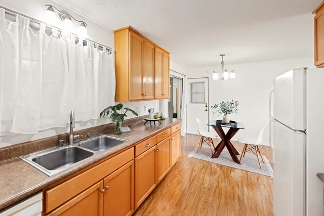a kitchen with stainless steel appliances a sink a counter space and a window