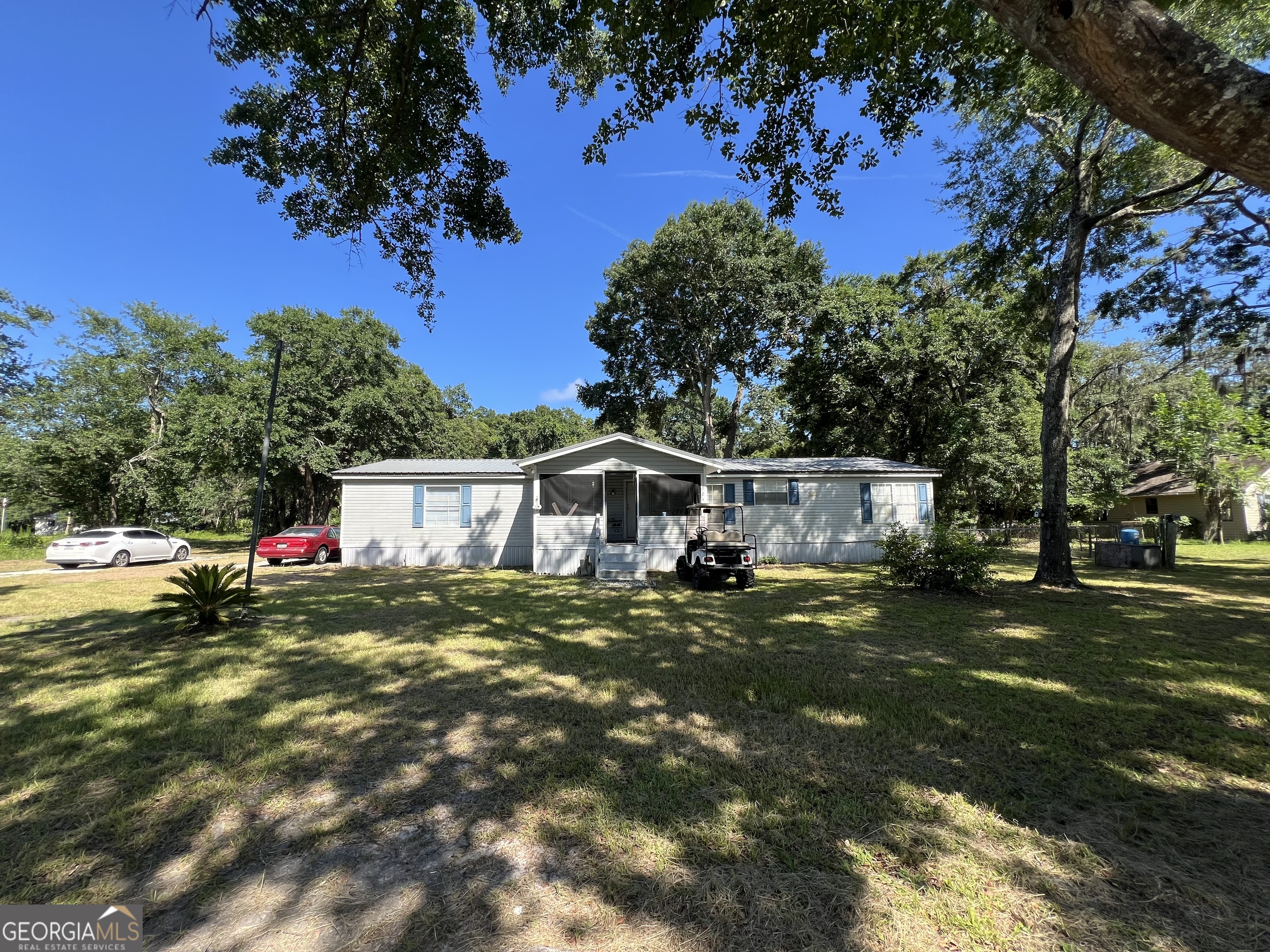 a view of a house with a tree and a yard