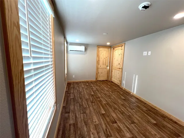 a view of a room with wooden floor and windows