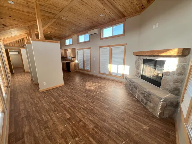 a view of a livingroom with furniture and a refrigerator