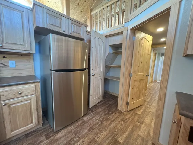 a kitchen with stainless steel appliances granite countertop a refrigerator and a stove top oven