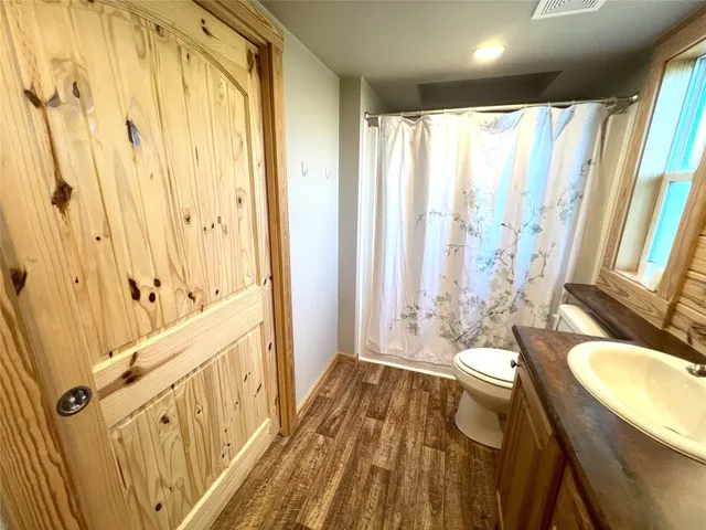 a spacious bathroom with a granite countertop tub sink and a mirror