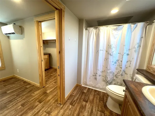 a bathroom with a toilet a sink and shower