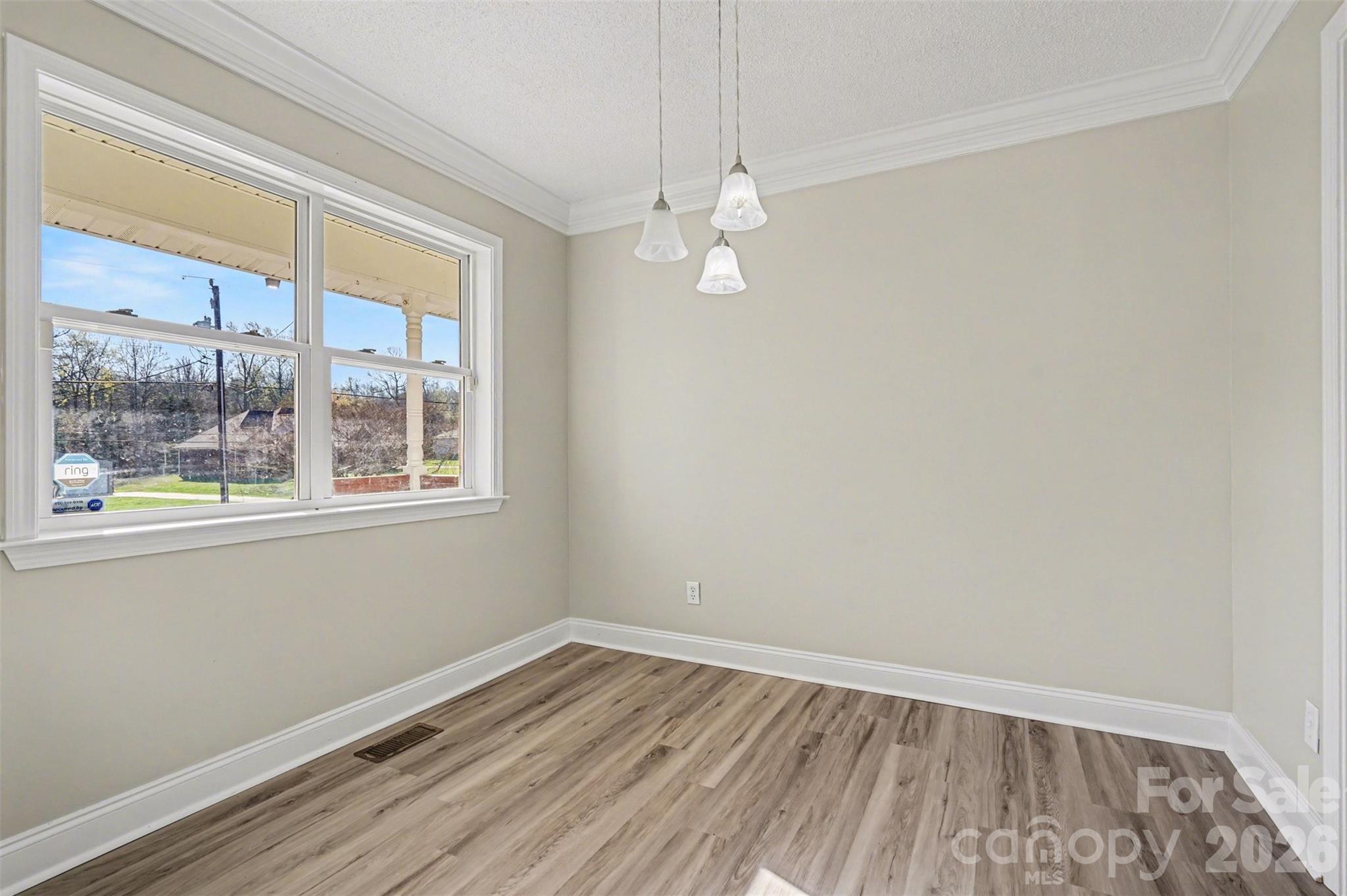 1050 Legion Club Road Salisbury, NC 28146 - Photo 12 of 29 an empty room with wooden floor and windows