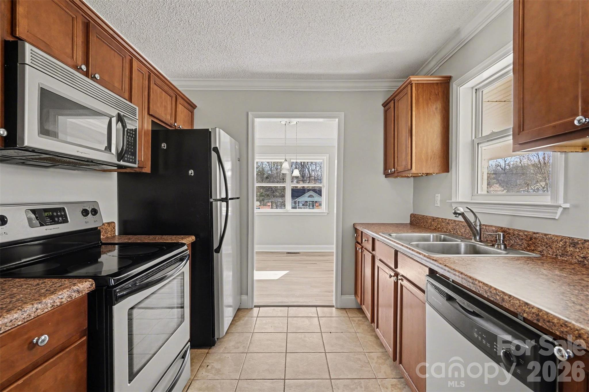 1050 Legion Club Road Salisbury, NC 28146 - Photo 13 of 29 a kitchen with stainless steel appliances granite countertop a stove and a refrigerator
