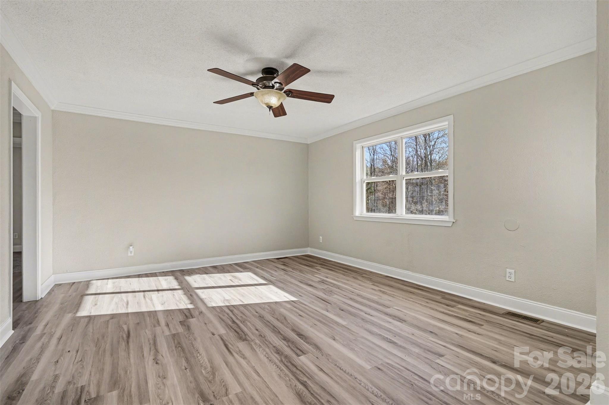 1050 Legion Club Road Salisbury, NC 28146 - Photo 5 of 29 a view of empty room with wooden floor and fan
