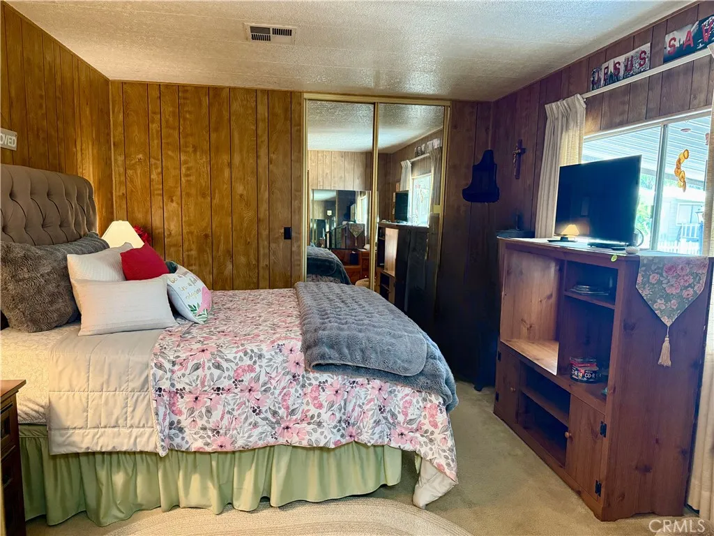 15181 Van Buren Riverside, CA 92504 - Photo 14 of 26 a bedroom with a bed and flat screen tv